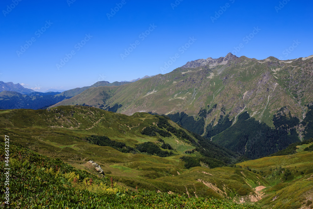 Fototapeta premium view of The Main Caucasian Ridge with rocky mountains and alpine meadows