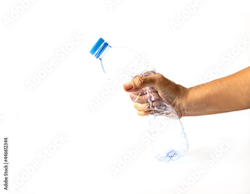 Hand squeezing Plastic Bottle isolated on white background. Concept  representing movement against pollution and for recycling.