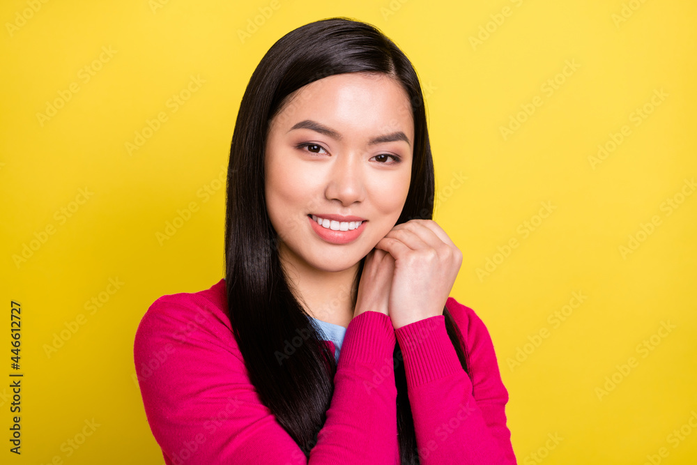 Photo of sweet brunette hair young lady hold hands wear pink sweater isolated on yellow color background Photo of sweet brunette hair young lady hold hands wear pink sweater isolated on yellow color background