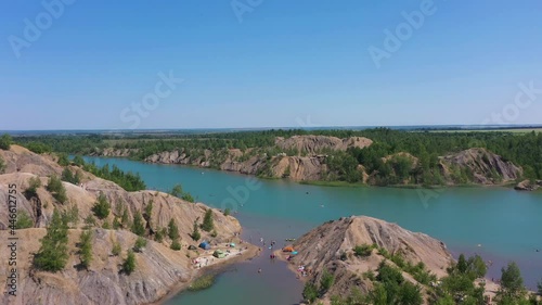 Romantsevskiye Mountains on a Sunny Summer Day. Konduki, Tula Region, Russia. People Sup Surfing and Swimming. Aerial View. Drone Flies Forward and Upwards. Reveal Shot photo