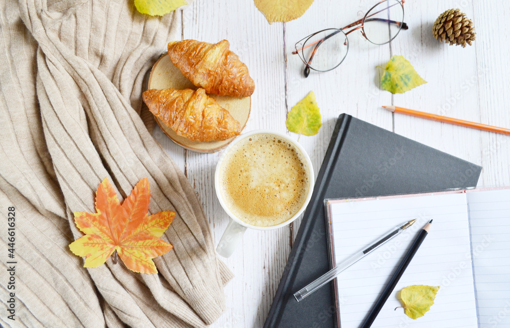 Cup of coffee with autumns leaves, diary and book on the white wooden texture. Back to school. September, October. Write and read, study  in relaxing atmosphere.  Work from home. Quarantine stay home.