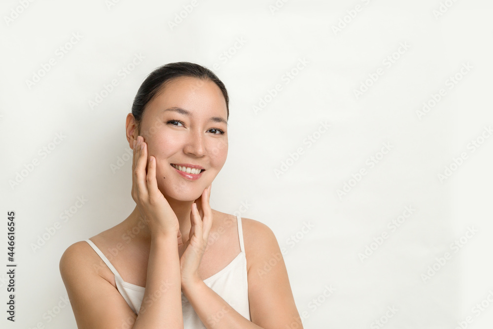 an attractive young Asian woman with perfect skin on a white background. the concept of facial care, prevention of aging and aging of the skin. an attractive young Asian woman with perfect skin on a white background. the concept of facial care, prevention of aging and aging of the skin.