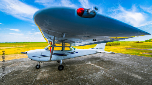 Light single engine school airplane parked on airfield