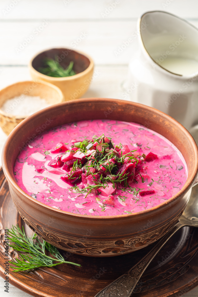 Cold borscht or Holodnik, traditional summer beet soup in ceramic bowl on wooden background Cold borscht or Holodnik, traditional summer beet soup in ceramic bowl on wooden background