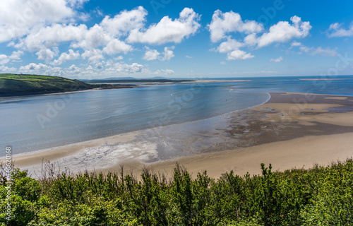 Panoramic shot of LLansteffan beach with clear blue water in southern Wales