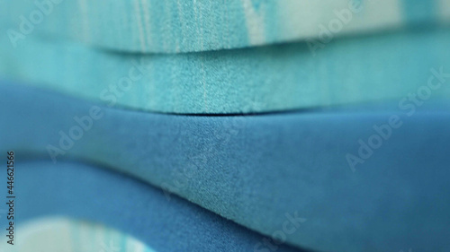 Piles of pastel blue sponge foam sheet materials of different thicknesse photo