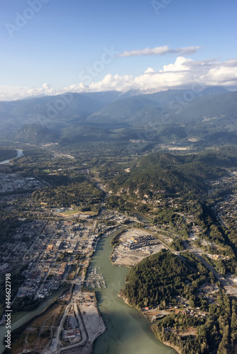 Aerial View from Airplane of a small touristic town  Squamish. Sunny Summer. Located in Howe Sound  North of Vancouver  British Columbia  Canada.