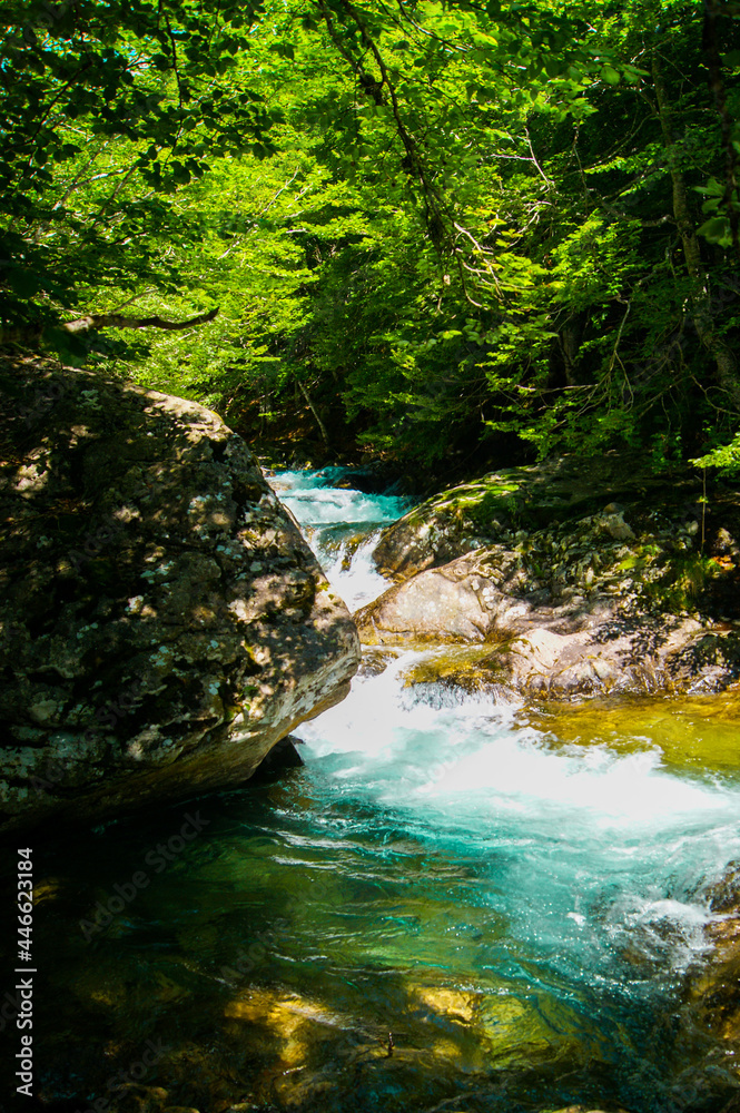 Secret natural pool with turquoise water located in a natural landscape.