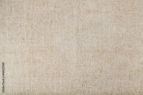Natural burlap fabric with fibers as background.