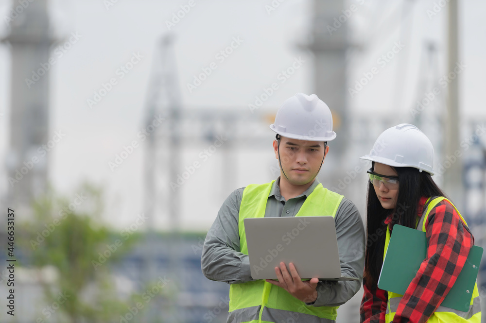Two engineer working at power plant,Work together happily,Help each other analyze the problem,Consult about development guidelines Two engineer working at power plant,Work together happily,Help each other analyze the problem,Consult about development guidelines