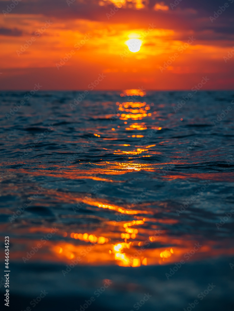 Sunset with clouds, warm colors and waves in ocean. Sunset with clouds, warm colors and waves in ocean.
