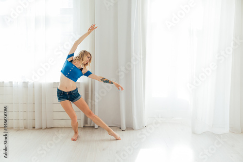 blonde woman dancing to music in training