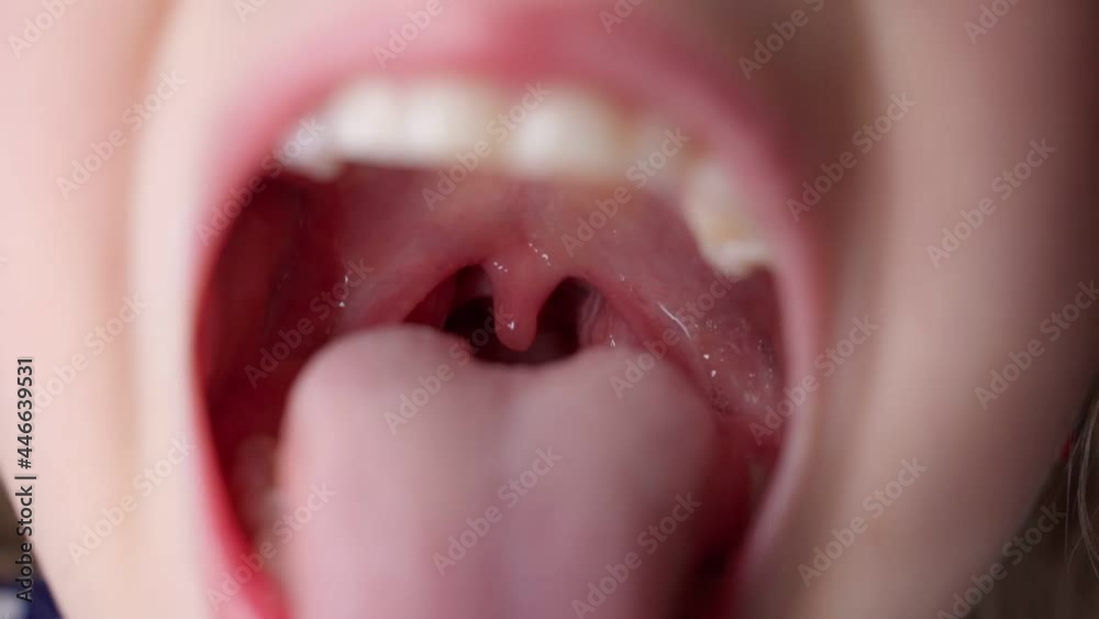 girl opens her mouth wide and pulls out long tongue. child ...    