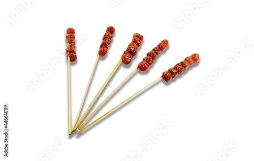 Sweet and sour gooseberry is skewed with bamboo. On a white background. Clipping path.