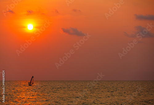 Surfer surfing alone in sea at sunset © Sura Nualpradid