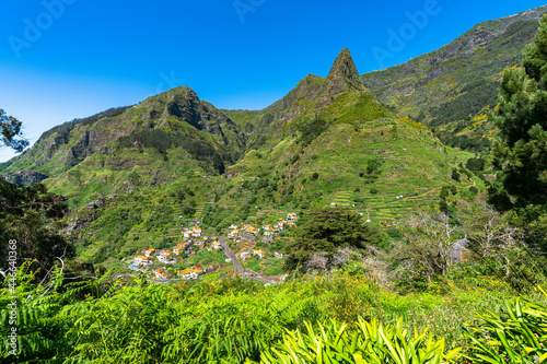 Village of Serra de Agua in the lush vegetation at feet of mountains, Ribeira Brava municipality, Madeira island, Portugal photo