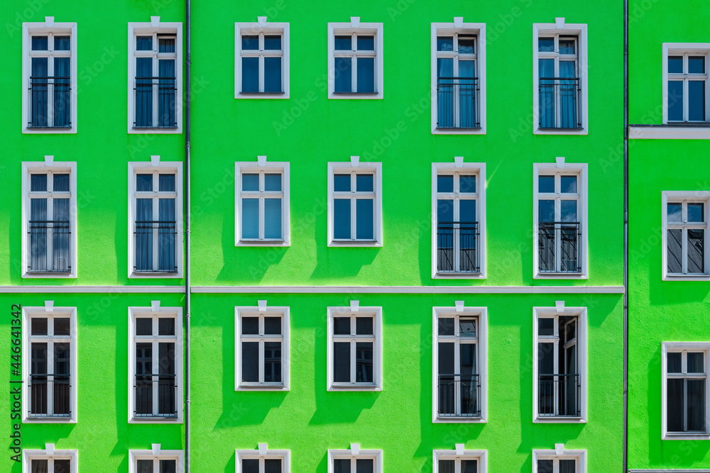 renovated apartment house with green facade, residential building exterior