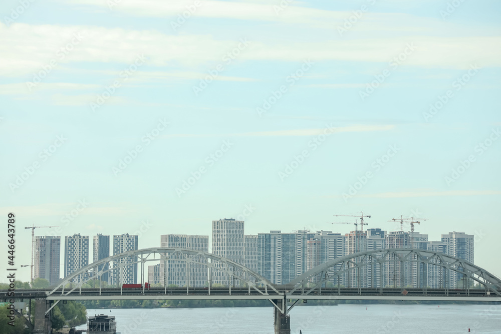 Beautiful view of cityscape with modern buildings and bridge over river Beautiful view of cityscape with modern buildings and bridge over river