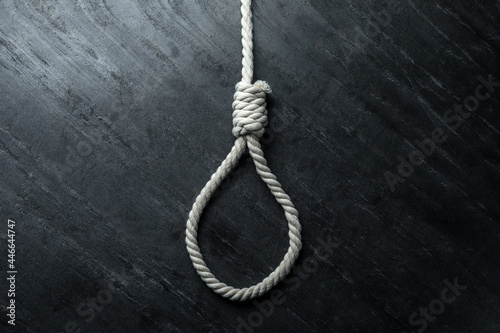 Rope noose on black table, top view