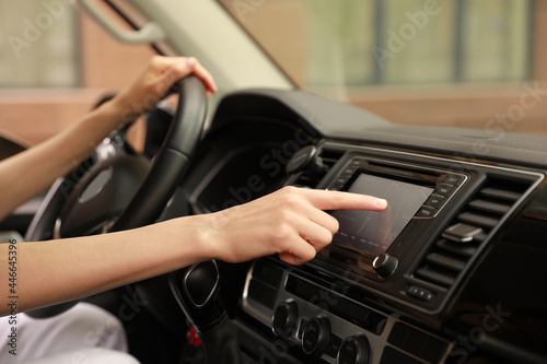 Woman using navigation system while driving car, closeup © New Africa