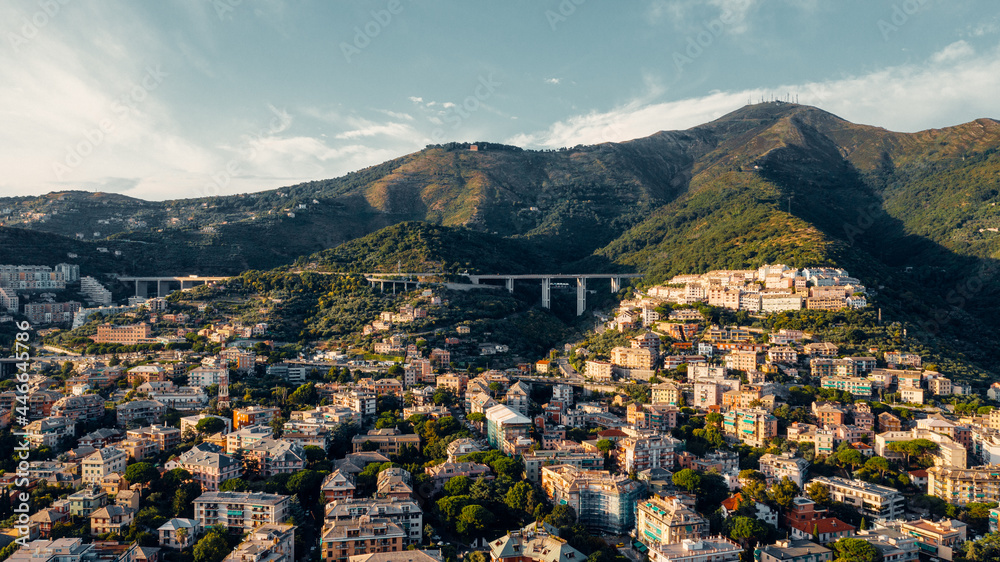 Aerial view from the sea over the city of Genoa, Italy. Suspended highway and infrastructure