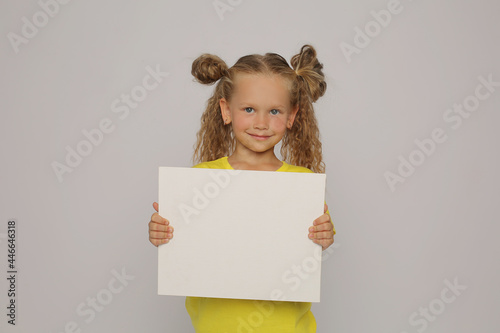 Obraz na plátně a beautiful happy blonde girl with ponytails in a yellow T-shirt horizontal phot