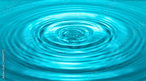 falling drops on the water surface, splash, ripples on the water, blue color