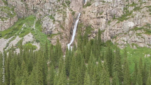 Aerial view of Burkhan Bulak waterfall. Burkhan-Bulak is the highest waterfall in Kazakhstan. Mountains of the Dzhungarskiy Alatau. General view of the waterfall from afar. photo