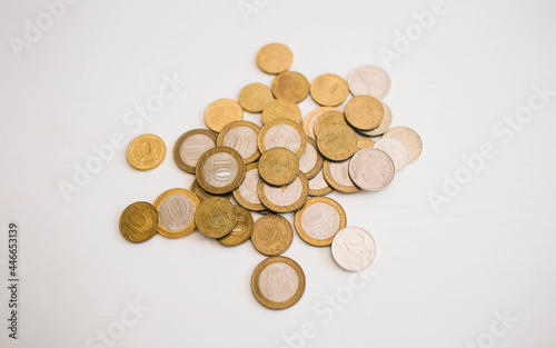 stack of coins made from different material on the white background