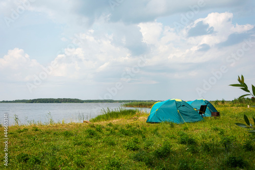 Tourist tents for camping on the lake shore  travel history. fishing  tourism  active recreation. Natural landscape. For lifestyle design. Outdoor recreation