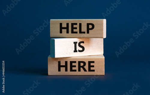 Help is here and support symbol. Wooden blocks with words 'Help is here' on beautiful grey background. Business, support, help is here concept. Copy space. photo