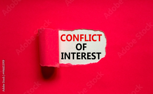 Conflict of interest symbol. Words 'Conflict of interest' appearing behind torn purple paper. Beautiful purple background. Business, conflict of interest concept, copy space.
