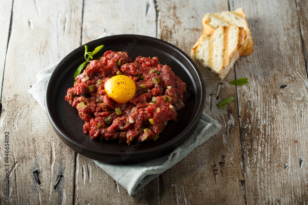 Traditional beef steak tartare with egg yolk Traditional beef steak tartare with egg yolk