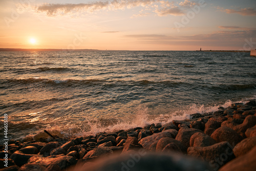 Evening landscape view of the Baltic sea. Sunset over the sea with beach © AlexGo