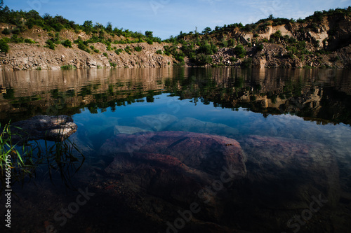 Radon Lake with clear turquoise water is an abandoned granite quarry. Ukraine.