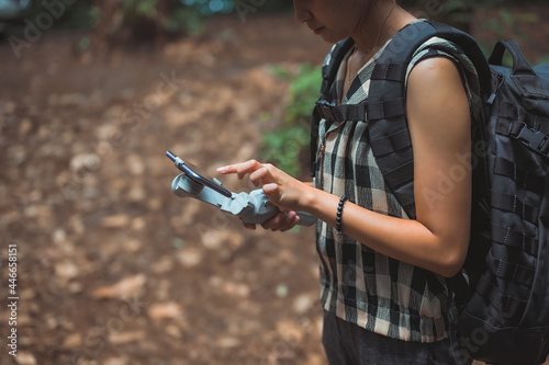 Young women using smart phone for searching direction in trekking route , inspiration , motivation and camping activity concept