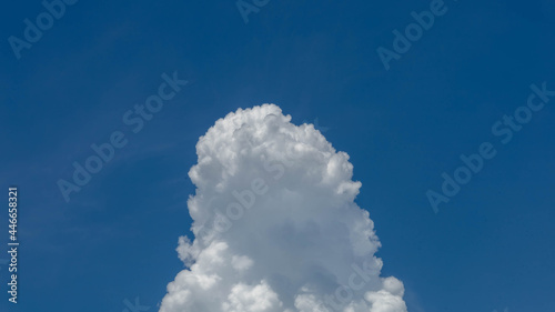 Massive cumulus cloud builds vertically before the storm.