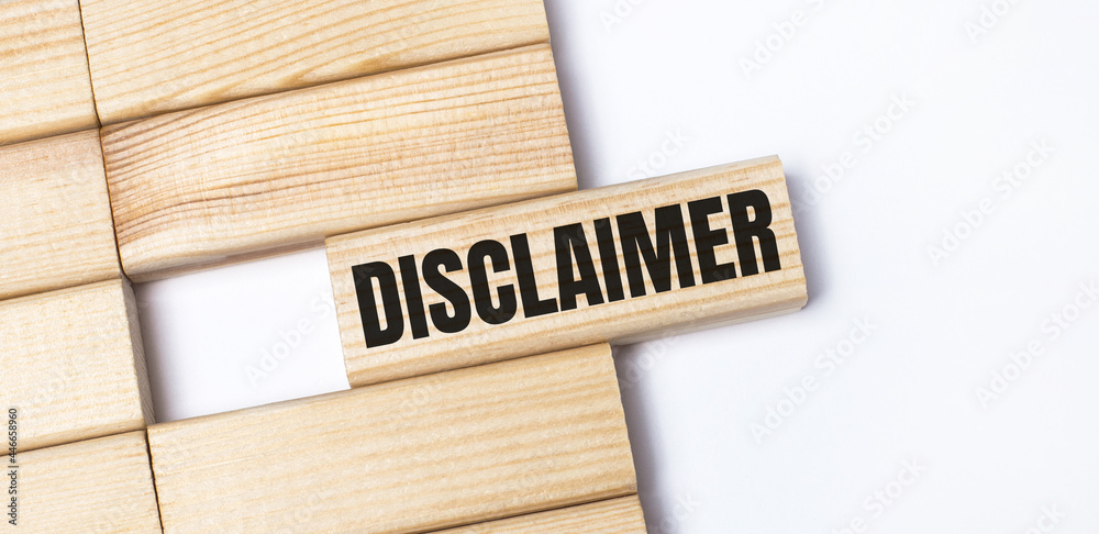 On a light background, wooden blocks with the text DISCLAIMER. Close-up top view. On a light background, wooden blocks with the text DISCLAIMER. Close-up top view.