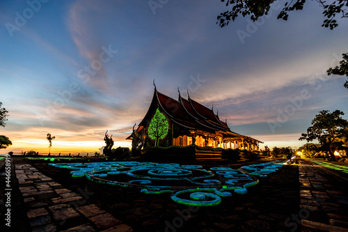 Beautiful of the tree pattern on the wall of Sirindhorn Wararam temple on Vivid sky background, Ubon Ratchathani Province, Thailand.
