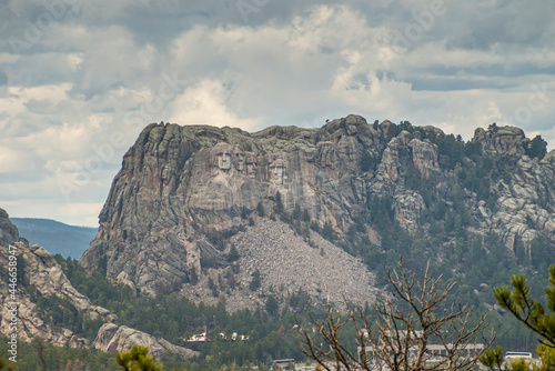 Black Hills, Keystone, SD, USA - May 31, 2008: Mount Rushmore and its mountain range. Seen from the road on opposing high ground  Heavy gray cloudscape. photo