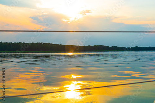 Sailing boat on the sea, a man on a beautiful golden sunset photo