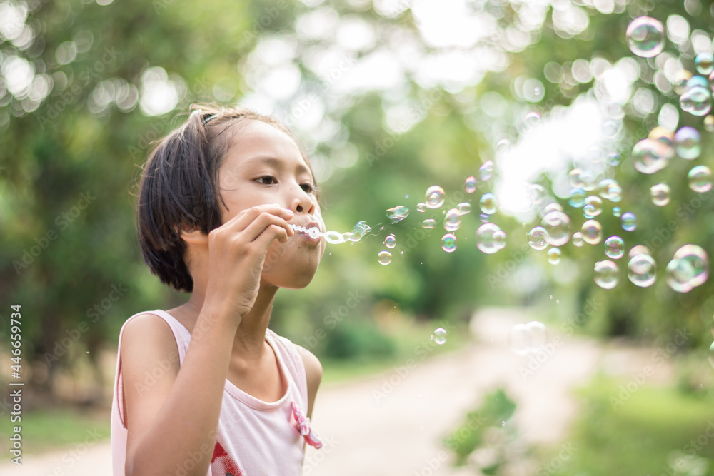 girl playing with blowing bubbles in the park. girl playing with blowing bubbles in the park.