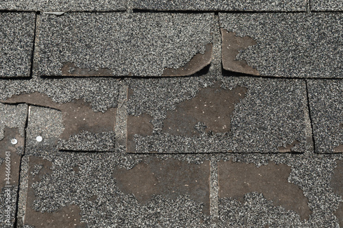 Broken worn asphalt roofing shingles fixit concept