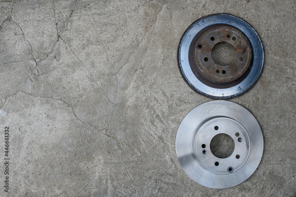 The old and new brake disc are on a gray background. Top view. Copy space