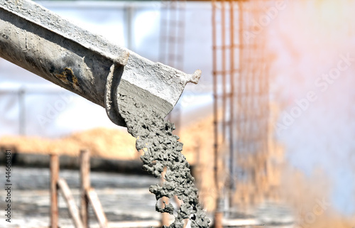 Industrial construction machinery workers pouring cement concrete