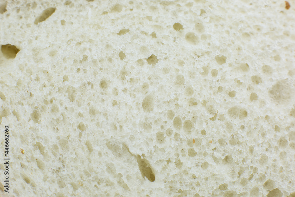 Loaf of white bread inside texture background. Bakery concept. Close up, macro photo.