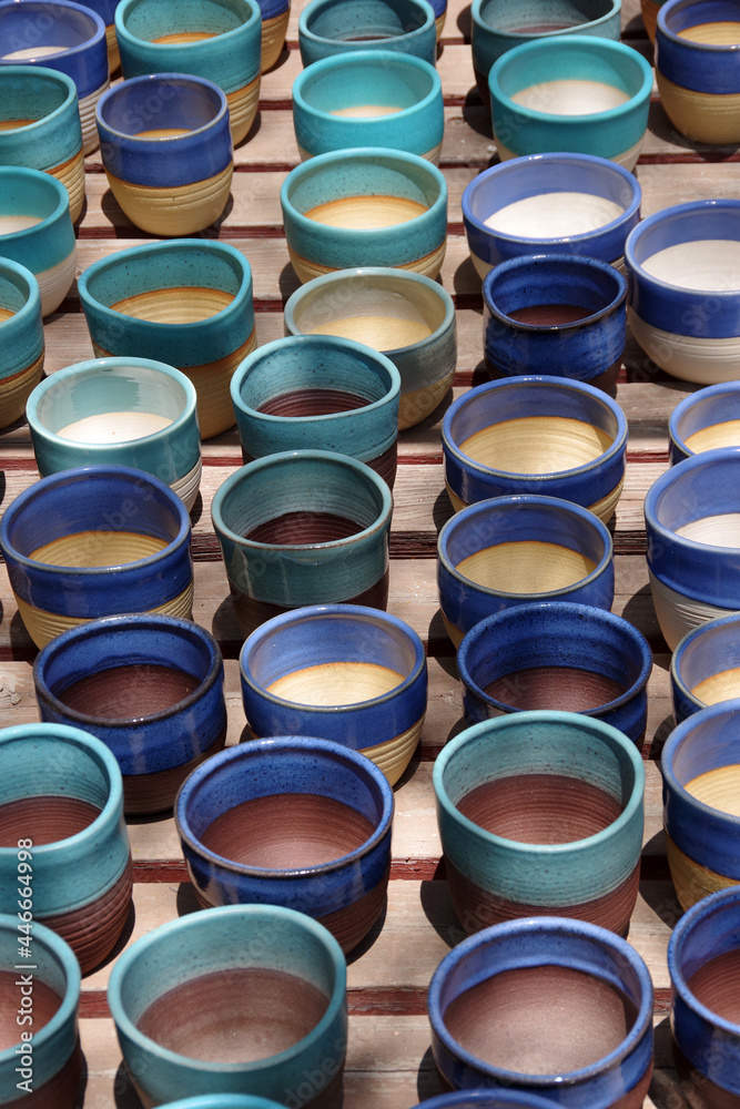 High angle view of a display of colorful handmade ceramic flowerpots High angle view of a display of colorful handmade ceramic flowerpots