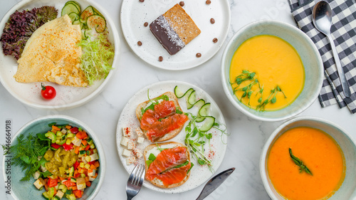 Wallpaper Mural Bowl with tofu and vegetables, bruschetta with salmon and cheese, omlet, pumpkin cream soup, totamo cream soup, banana cake top view on white marble table Torontodigital.ca