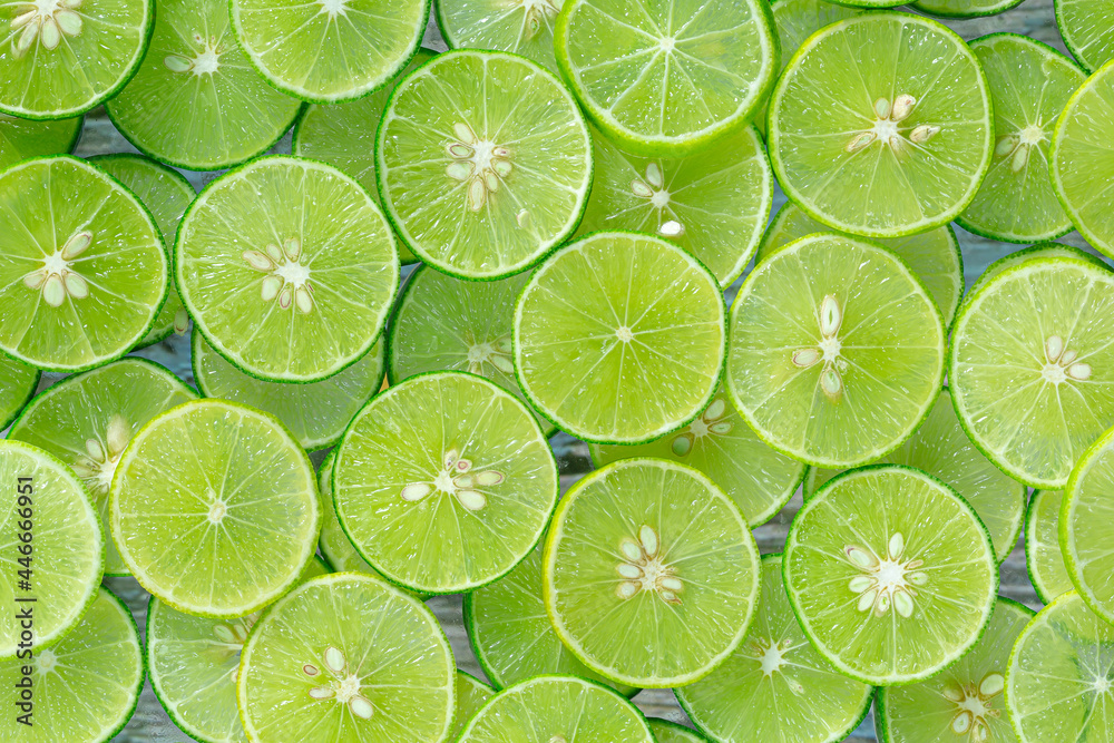 Macro Lime,Fresh lime slices as a background,Lemon and green lime overlapped slices close-up background.