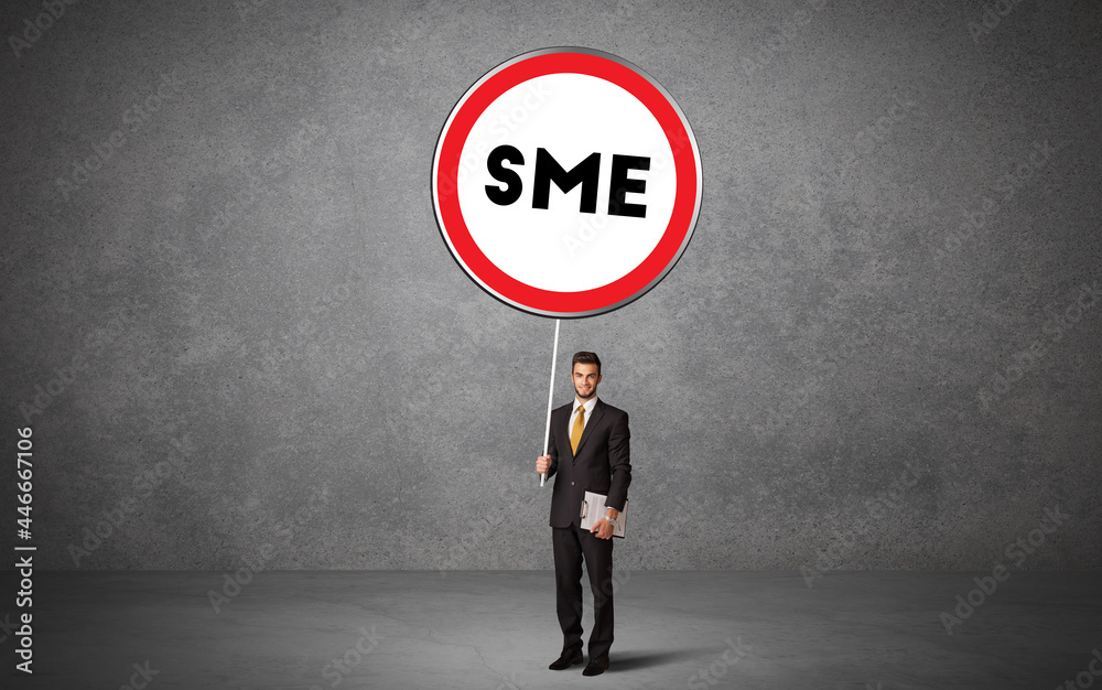 Fototapeta premium Young business person holdig traffic sign